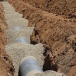 Detailed view of drainage pipe construction in a trench, Elk Grove, California.